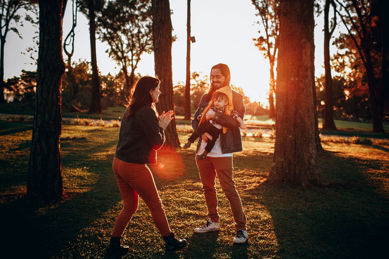 A happy family walking together at sunset