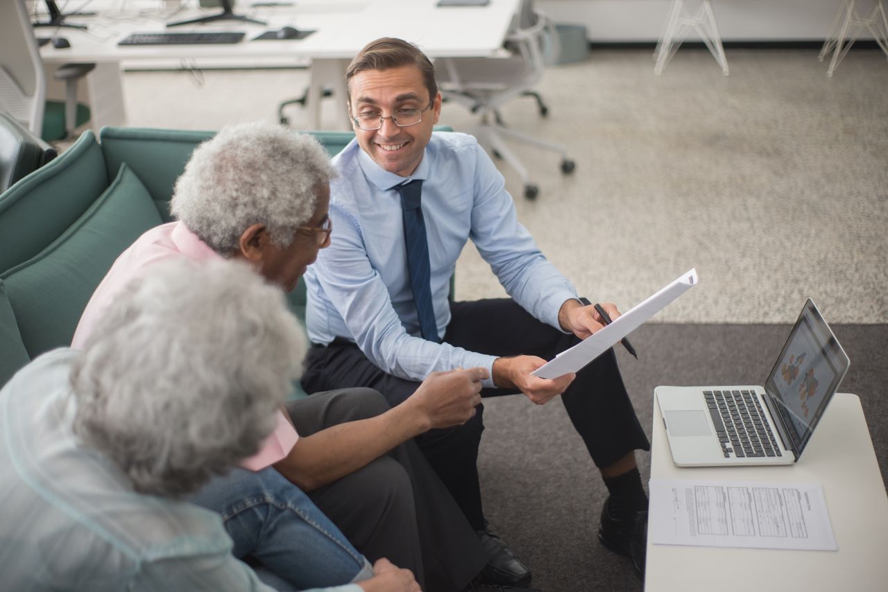 An advisor reviewing policy documents with a client